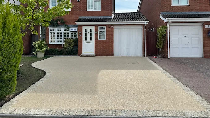 Curved resin bound driveway edged with granite setts