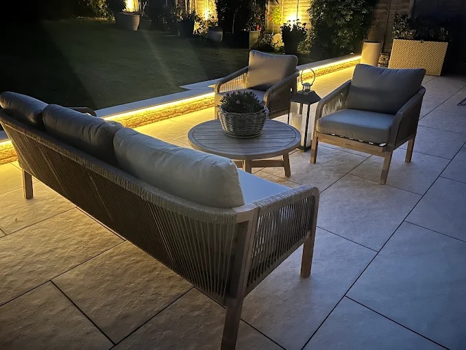 Porcelain patio seating area lit by LED strip lighting at dusk